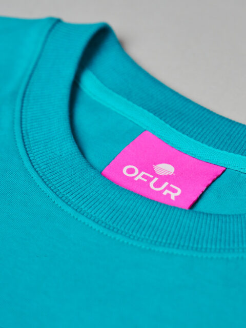 Close up of the OFUR neck label in the original magenta T-Shirt green
