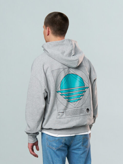 Model wearing the grey OFUR hoodie with a blue print on the back of the hoodie