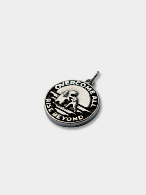 The front of the Sterling silver OFUR pendant with the text overcome all rise beyond