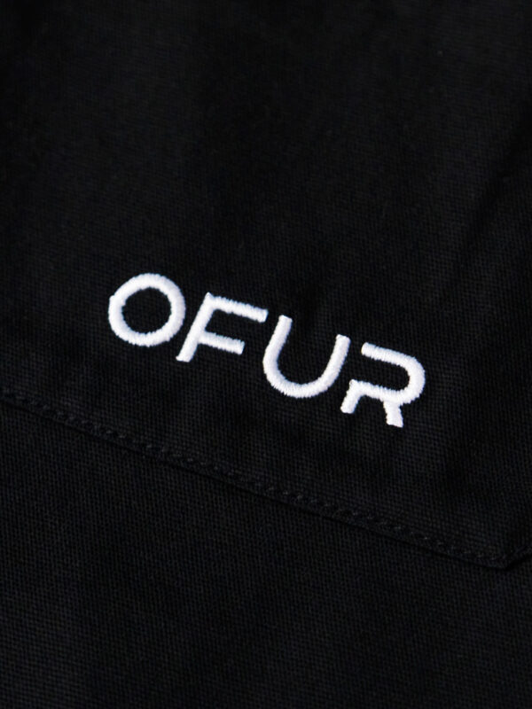 Close up of the OFUR embroidery on the pocket of the pants