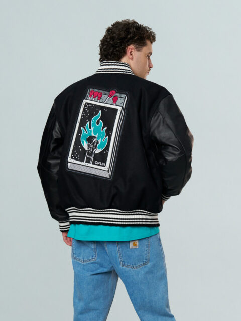 Model wearing the black OFUR Fire punch varsity jacket seen from behind