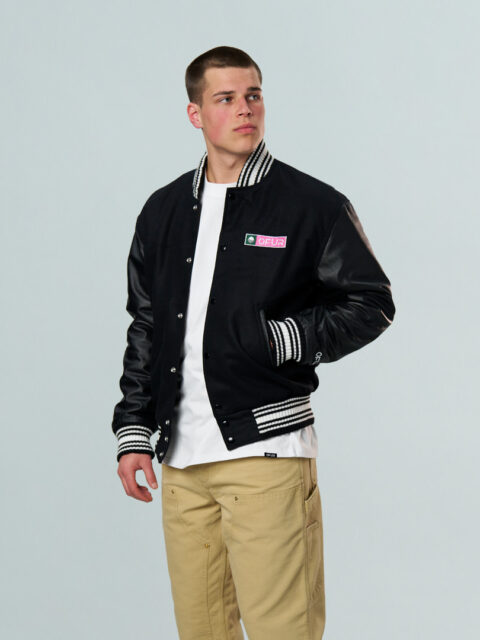 Model wearing the black OFUR varsity jacket seen from the front
