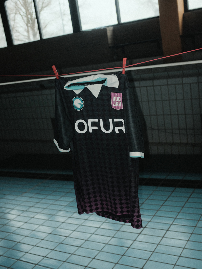 KOPJEK x OFUR Football Jersey hanging on a clothesline in an empty swimming pool