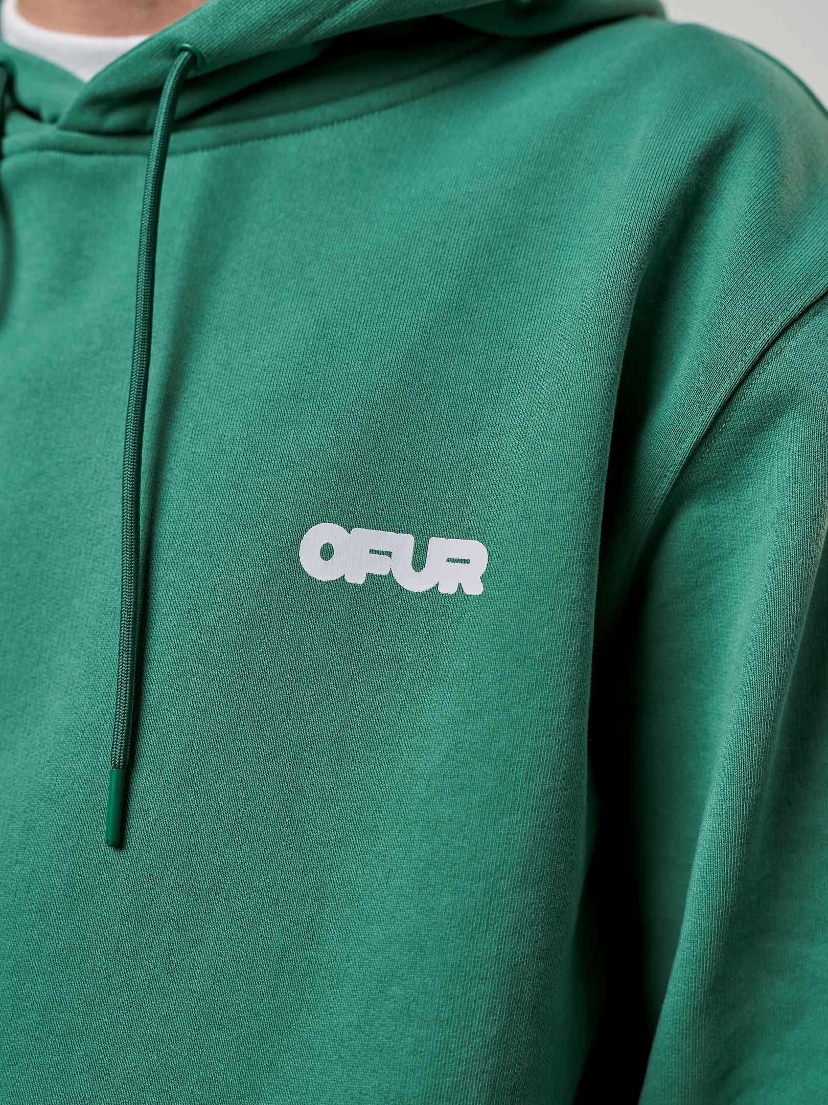 OFER_FW25_FATNESS_GREEN_HOODIE_CLOSE_UP_FRONT_1